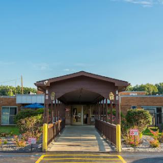 A welcoming entrance featuring an accessibility ramp and beautifully landscaped surroundings.