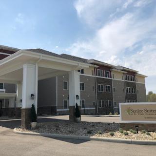 A modern hotel entrance with a welcoming faade and clear skies.