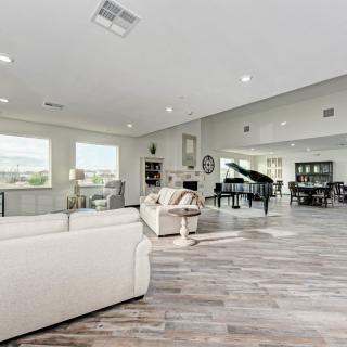 Spacious and modern living room with a grand piano and elegant furnishings.