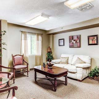 A cozy living room with a sofa, chairs, and a coffee table.