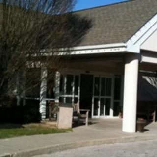 An entrance to a building featuring columns and an awning.