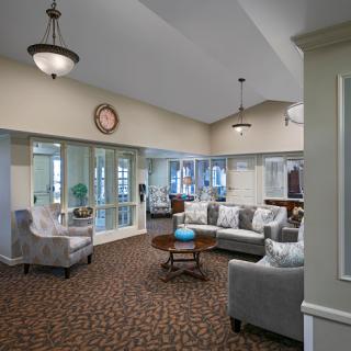 A cozy and inviting lobby area featuring comfortable seating, elegant lighting, and a warm atmosphere.