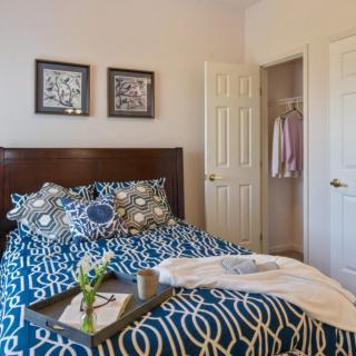 A well-decorated bedroom with a stylish bed and patterned bedding, showcasing a cozy and inviting atmosphere.