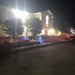 A house decorated with bright holiday lights at night.