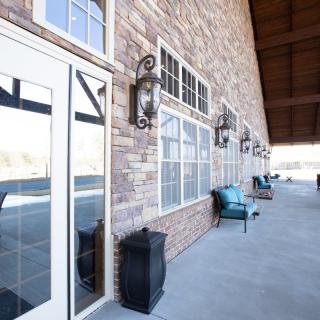 A spacious patio with comfortable outdoor seating and classic stone wall accents.