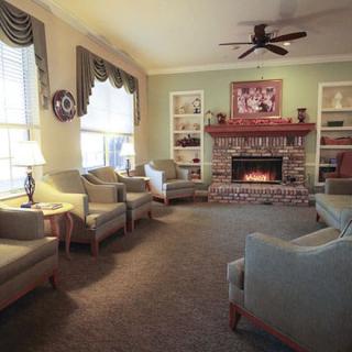 A cozy living room with comfortable seating and a warm fireplace.