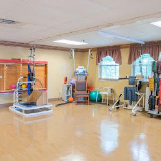 A well-equipped rehabilitation and physical therapy room featuring various exercise equipment.