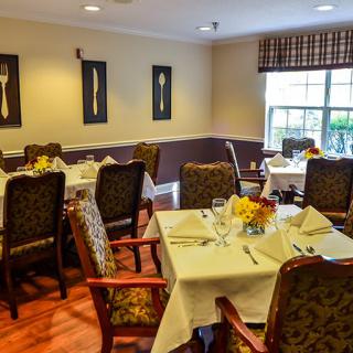 A cozy dining room with elegantly set tables and classic decor.