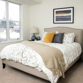 Cozy bedroom with stylish decor and a comfortable bed.