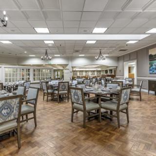 An elegant dining room with neatly arranged tables and chairs, ready for guests.