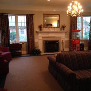Cozy living room with a fireplace and elegant chandelier.