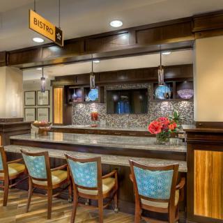 A modern hotel lobby bar with stylish seating and elegant lighting.