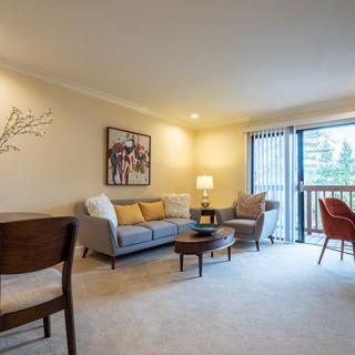 A cozy and inviting living room with comfortable seating and ample lighting.