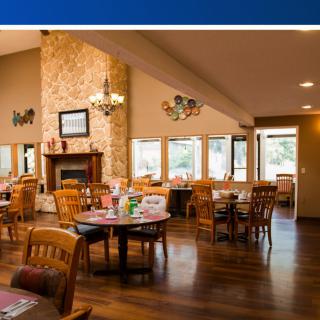 A cozy restaurant interior with wooden furniture and a fireplace.