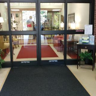 An inviting entrance displaying a stylish lobby with comfortable seating and decorative elements.