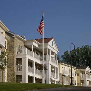 A residential building with an American flag on a clear day.