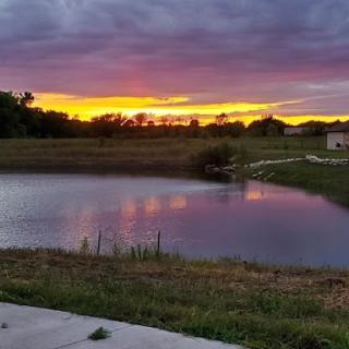 A beautiful sunset illuminating the sky over a tranquil lake.