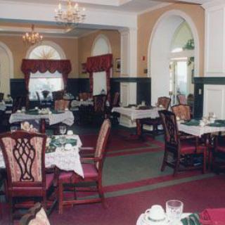 An elegant restaurant interior with neatly arranged tables and chairs in a formal dining setting.