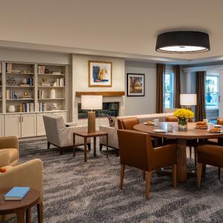 A cozy living room with a library corner featuring comfortable seating and elegant decor.
