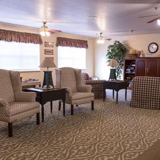 A cozy living room with comfortable seating, side tables, and decorative lamps.