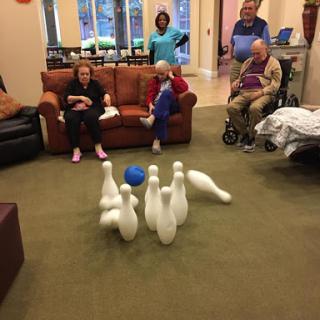 Residents enjoying a fun bowling activity at the community center.