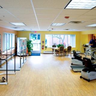 A bright and spacious rehabilitation center equipped with therapy and exercise machines.