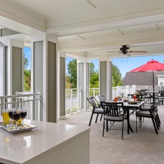 Spacious outdoor patio with dining area and modern furnishings.