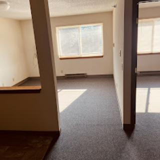 An empty interior space with natural light coming through a window.