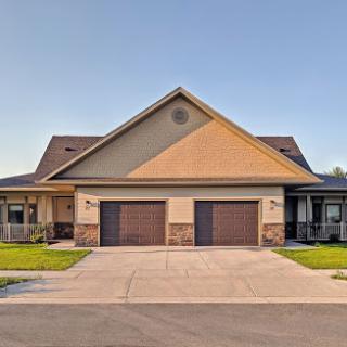 A modern duplex featuring dual garages and a well-manicured front yard.