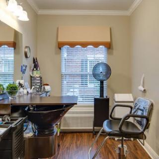 A stylish and modern hair salon interior featuring a styling station and comfortable seating.
