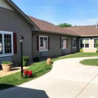 A residential house with a curved driveway and well-maintained garden.