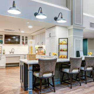 A modern kitchen with a spacious countertop and stylish bar stools.
