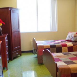 A cozy bedroom with twin beds and colorful quilts.
