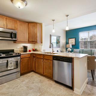 A modern kitchen with stainless steel appliances and wooden cabinets.
