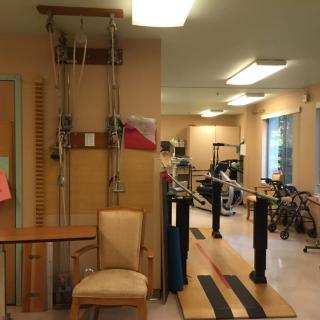 A physical therapy room equipped with various rehabilitation and exercise machines.