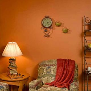 A cozy living room corner with an armchair, books, and a warm lamp.