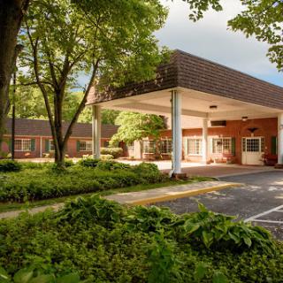 A serene view of a well-designed structure surrounded by lush greenery.
