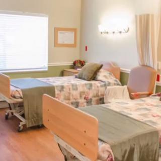 A clean and well-lit hospital room with two patient beds.