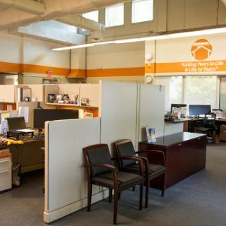 A modern office layout featuring cubicles and workstations, creating a collaborative workspace.