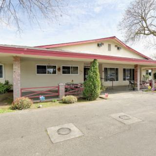 A charming single-story residential building with a welcoming exterior and well-maintained landscaping.