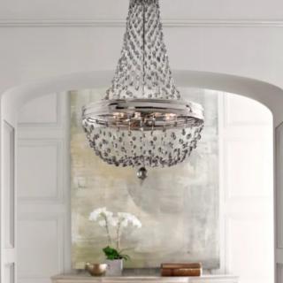 A luxurious chandelier hanging in a beautifully designed interior space.