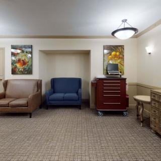 A well-lit waiting area with various seating options and artwork on the walls.