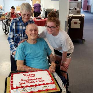 A joyful family gathering to celebrate a special anniversary with cake and smiles.