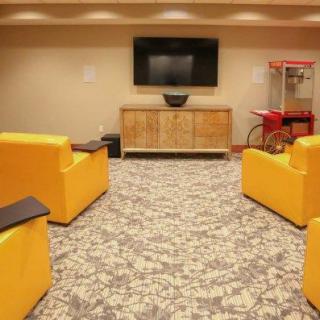 A cozy living room setup with bright yellow chairs and a popcorn machine.
