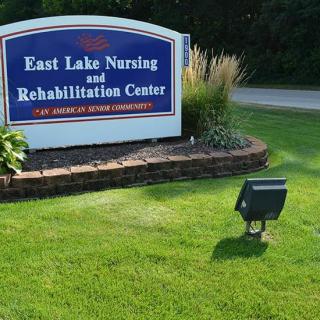 Sign for East Lake Nursing and Rehabilitation Center surrounded by landscaping.