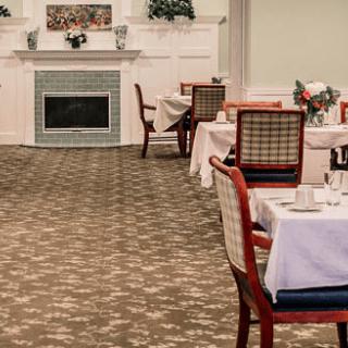 A cozy dining area with neatly arranged tables and chairs, complete with tablecloths and elegant decor.