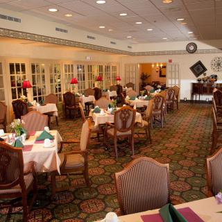 An elegant dining room with neatly arranged tables and chairs.