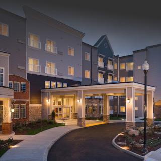 A well-lit hotel building entrance at night.