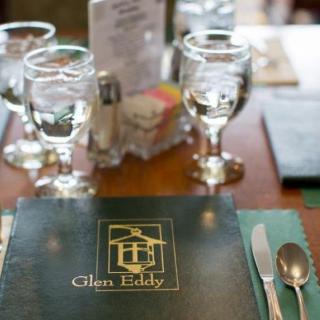 A table set for dining with a menu labeled 'Glen Eddy' alongside glassware and cutlery.