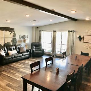 A stylish and spacious living and dining area with modern furnishings and plenty of natural light.
